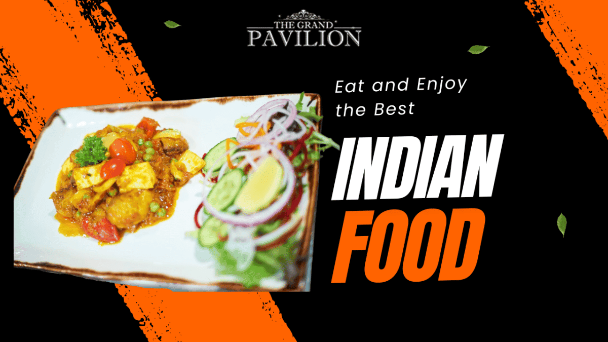 Traditional Indian dish served with fresh vegetables and lemon wedge, vibrant cuisine at The Grand Pavilion.