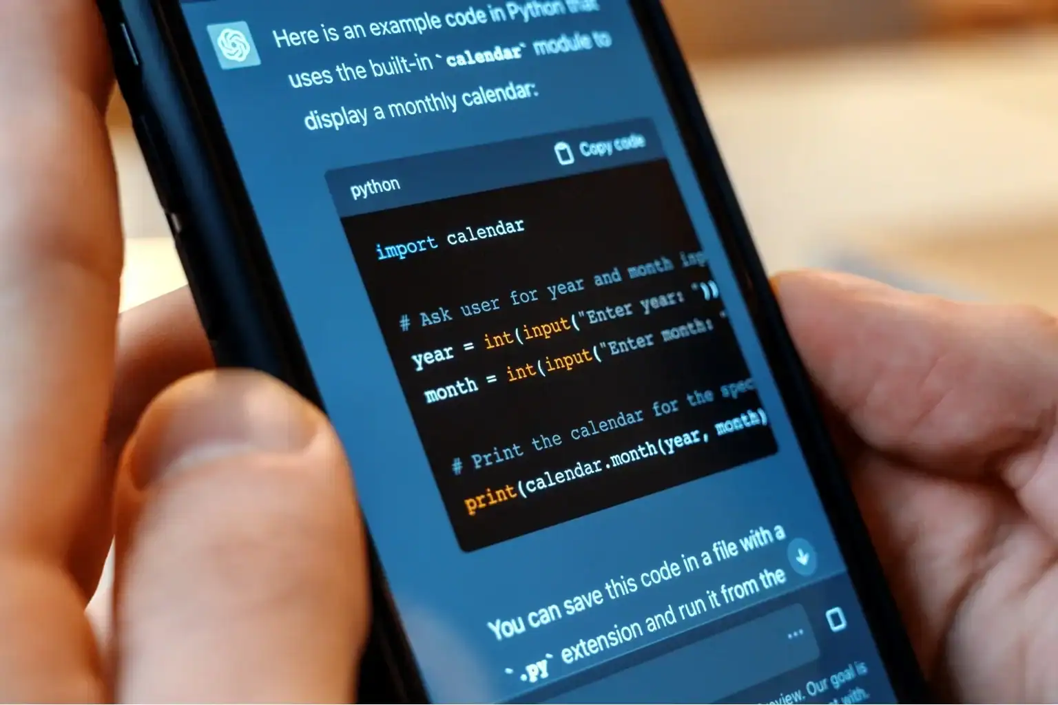Python calendar code snippet on smartphone screen.