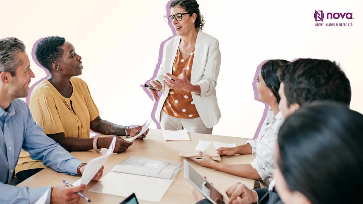 Diverse team discussing around meeting table.