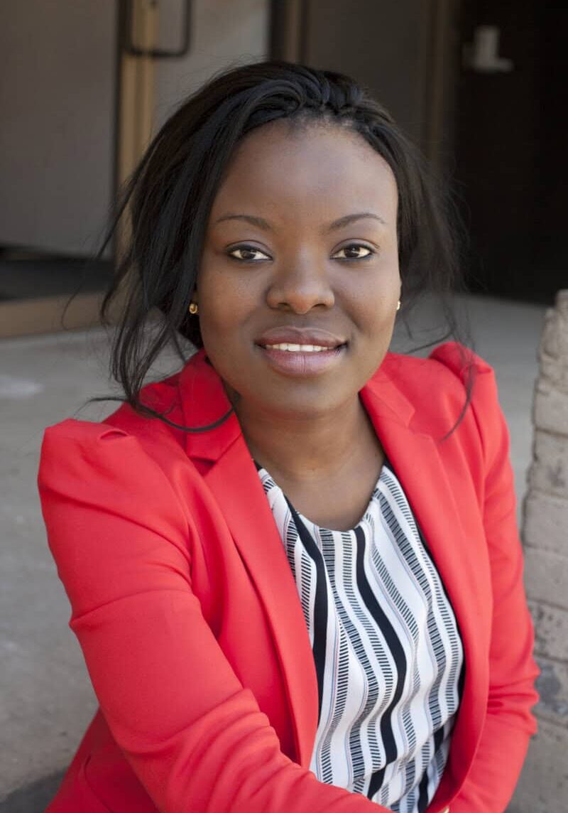 Facie Chiwanza Woman in red blazer smiling outdoors