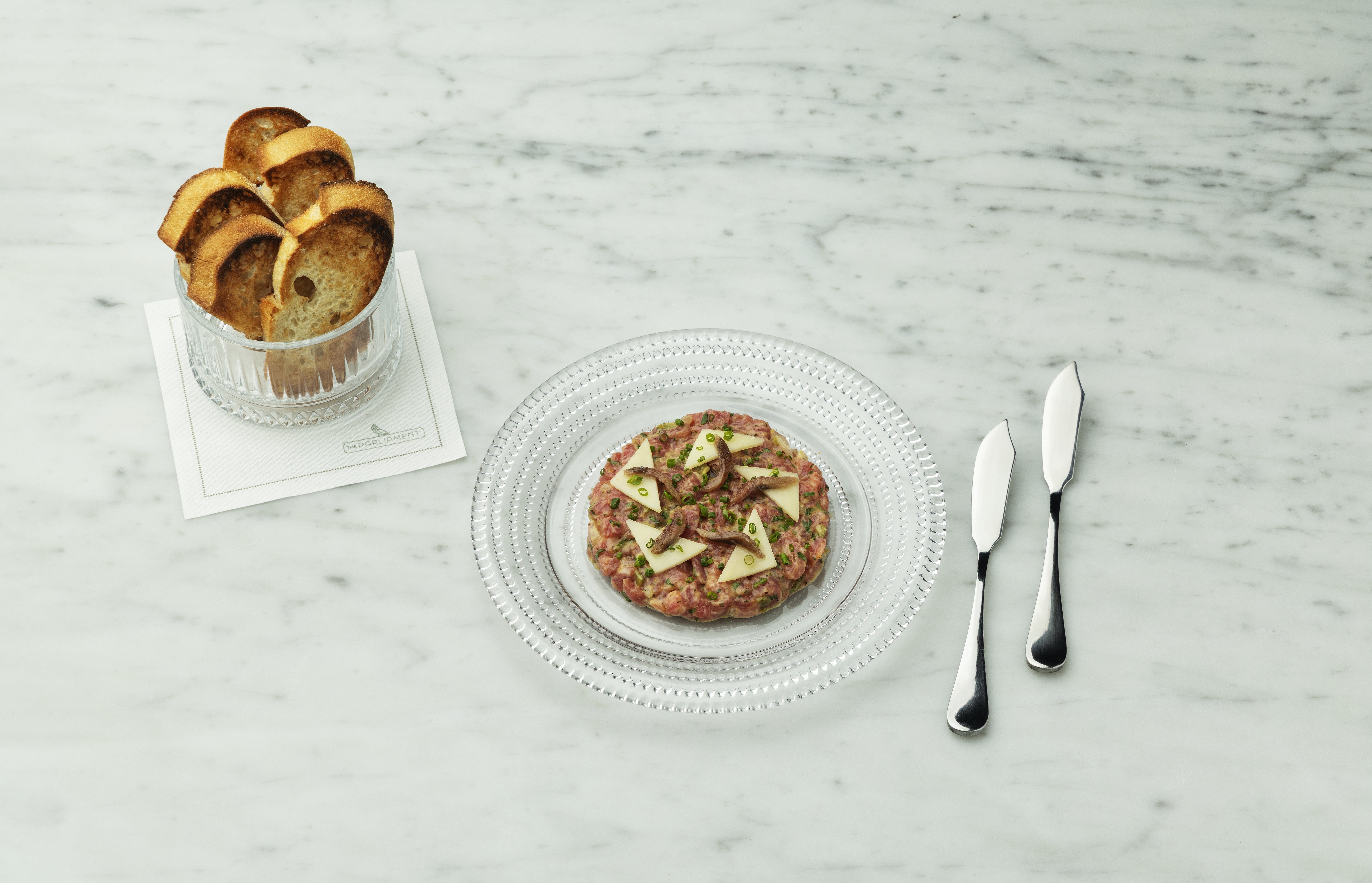 Plated tartare with baguettes.