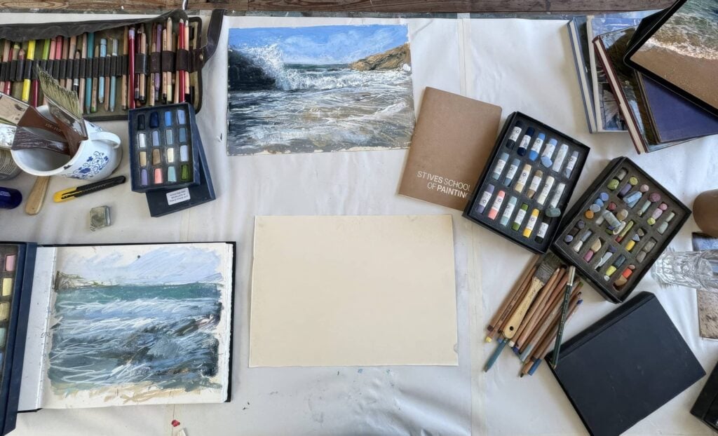 Artist Nina Squire's studio with soft pastels and landscape sketches.