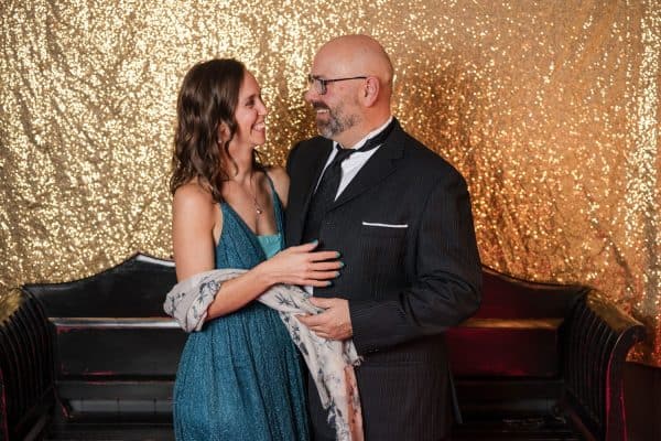 DJ Funkiphil posing with a guest at a formal event