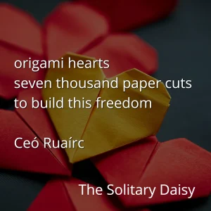 A yellow origami heart is surrounded by red origami hearts. Overlaid text features a short poem and the title "The Solitary Daisy" by Ceó Ruaírc.