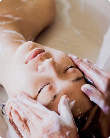 image of a woman having her head massaged