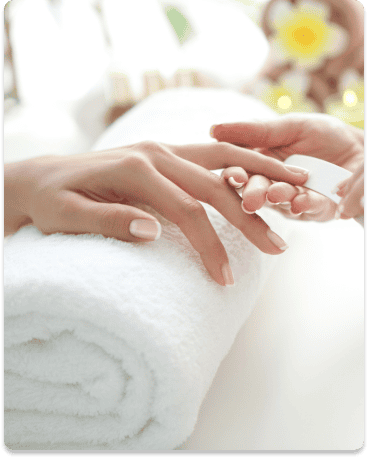 hand on a while towel getting her nails painted
