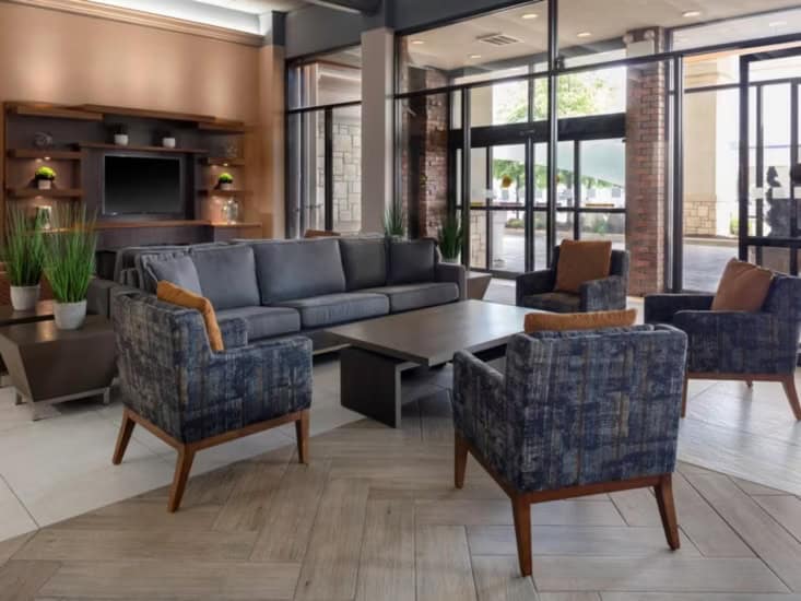 Seating area in the lobby with armchairs and a coffee table. Gallery Image