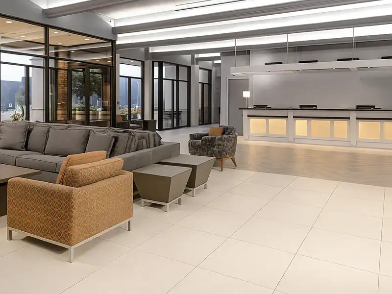 View of the inside lobby, showing a counch and front desk in the back. Gallery Image