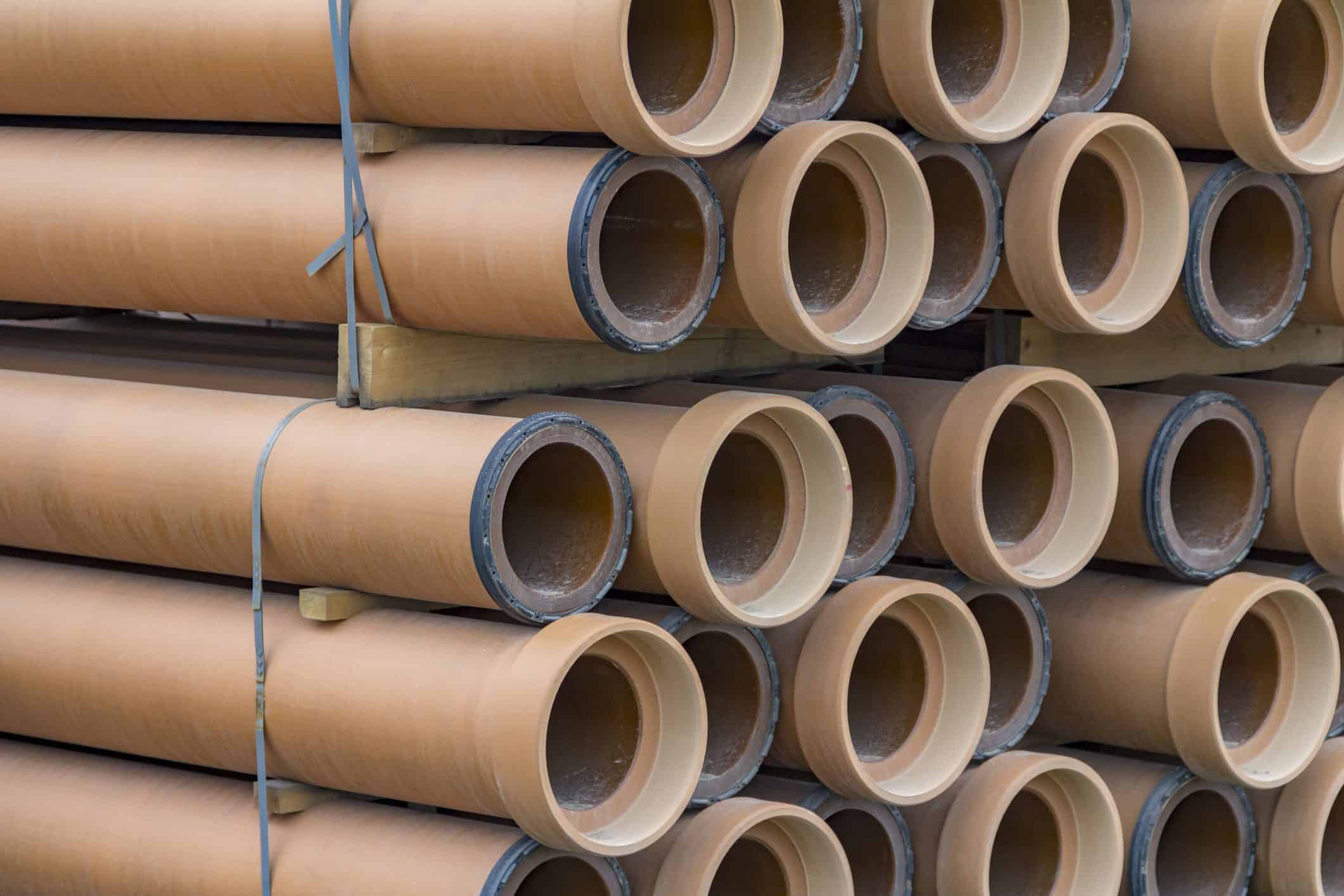 New clay pipes ready for replacement in underground plumbing systems.