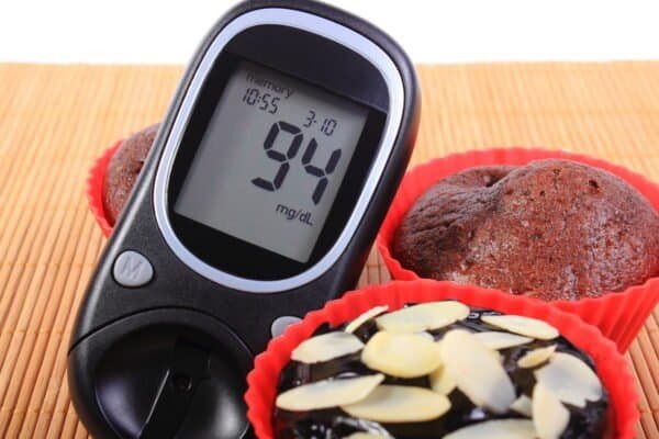 Glucose Meter And Homemade Delicious Fresh Baked Chocolate Muffins In Red Silicone Cups, Concept