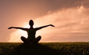 Woman doing yoga at Sunset
