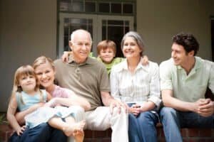 Group picture of three generations family sitting on the terrace