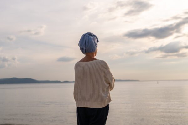 Moment friend support, resilience, and compassion, often associated with of battling cancer wearing a headscarf, a common symbol of strength among cancer patients undergoing treatment.