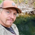 Man by a serene water body.