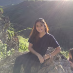 Person sitting on rocky mountain