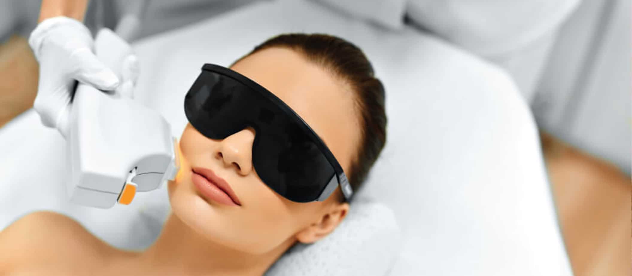 woman receiving laser rejuvenation treatment on her face