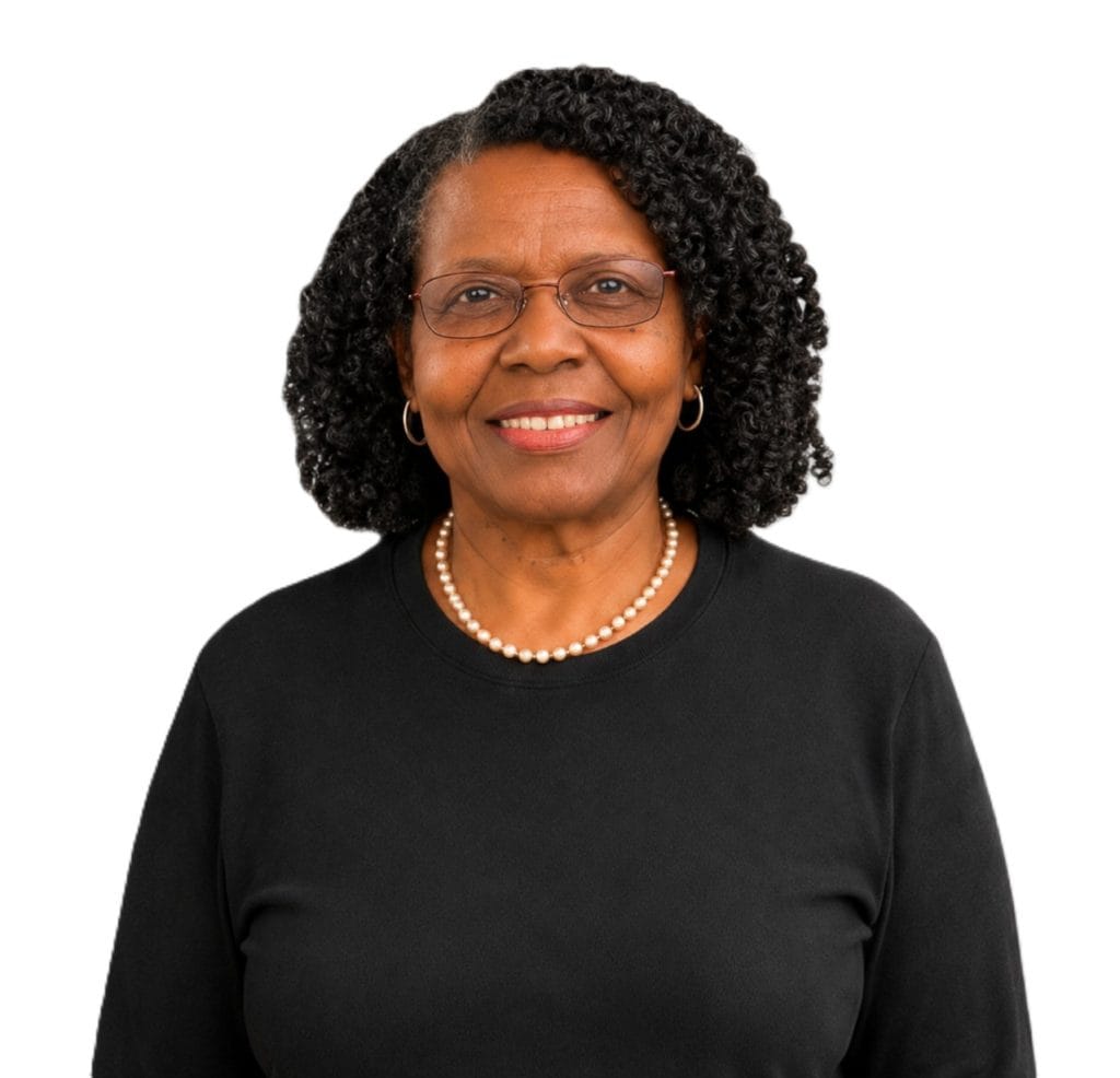 Portrait of a smiling mature woman with glasses and curly hair in black top.