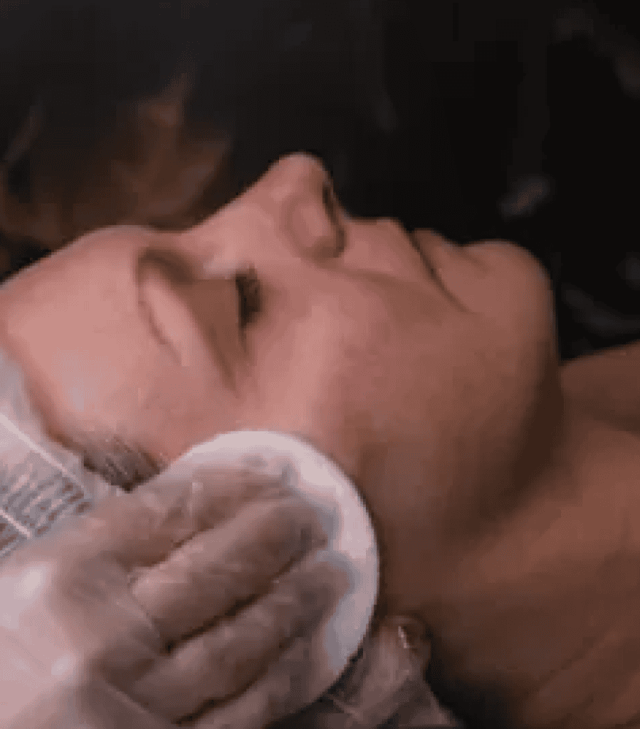 Woman receiving a facial treatment for clear, healthy skin at Tonic Day Spa.