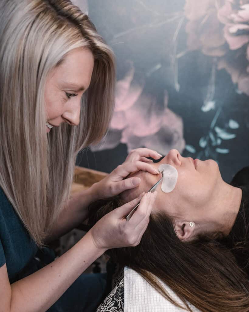 Pregnant woman receiving facial treatment, promoting relaxation and skincare during pregnancy.