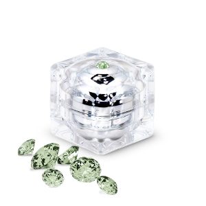 Byonik® High Energy Power Mask in a clear jar with green gemstones around it.