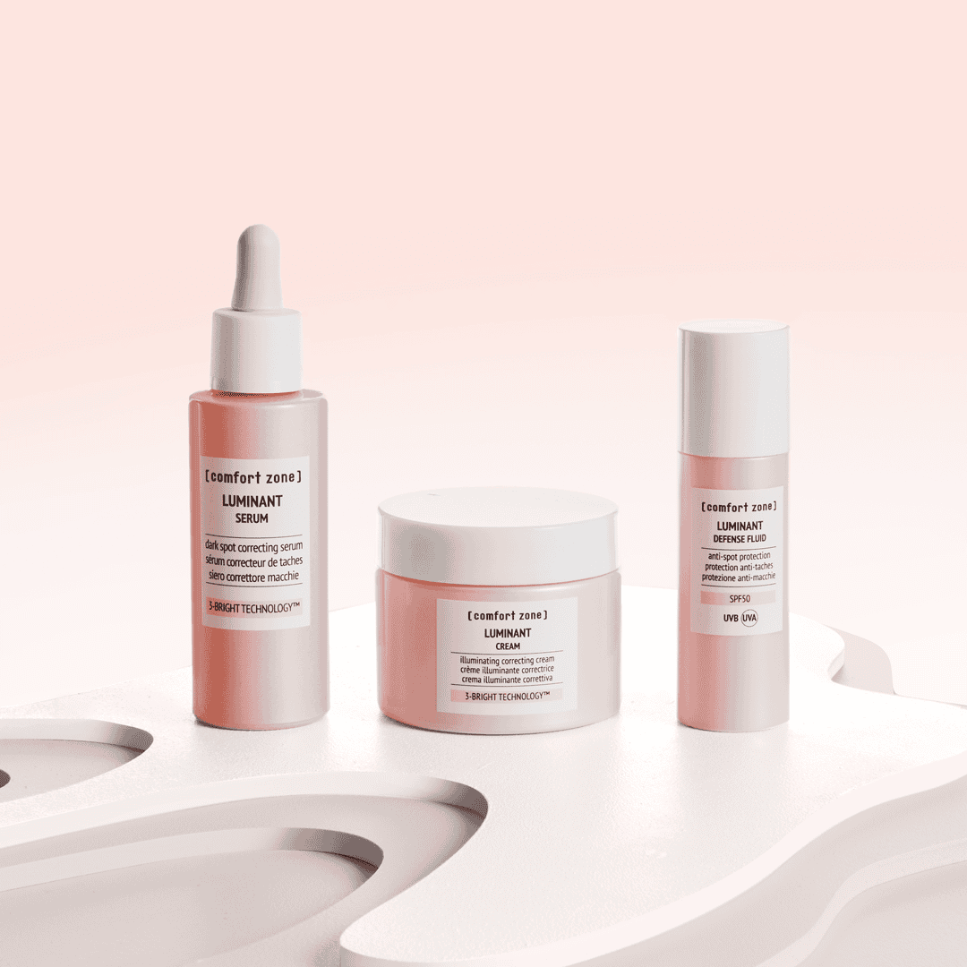 Skincare products including serum, cream, and fluid on a white surface.