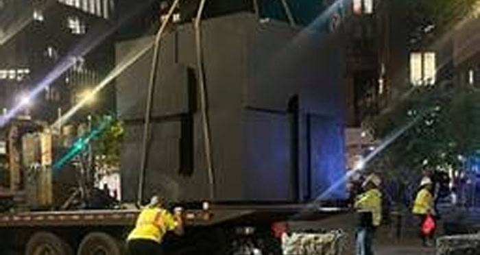 Astor Place Cube being loaded onto flat bed truck