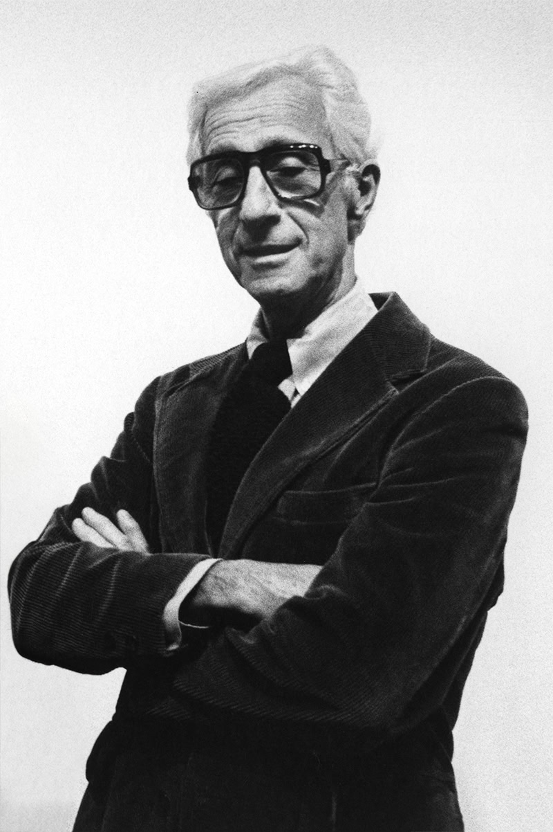 Tony Rosenthal crossing arms in a suit