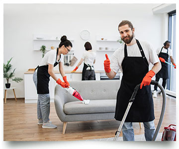 Professional cleaning team cleaning a modern living room with vacuum and cleaning tools.