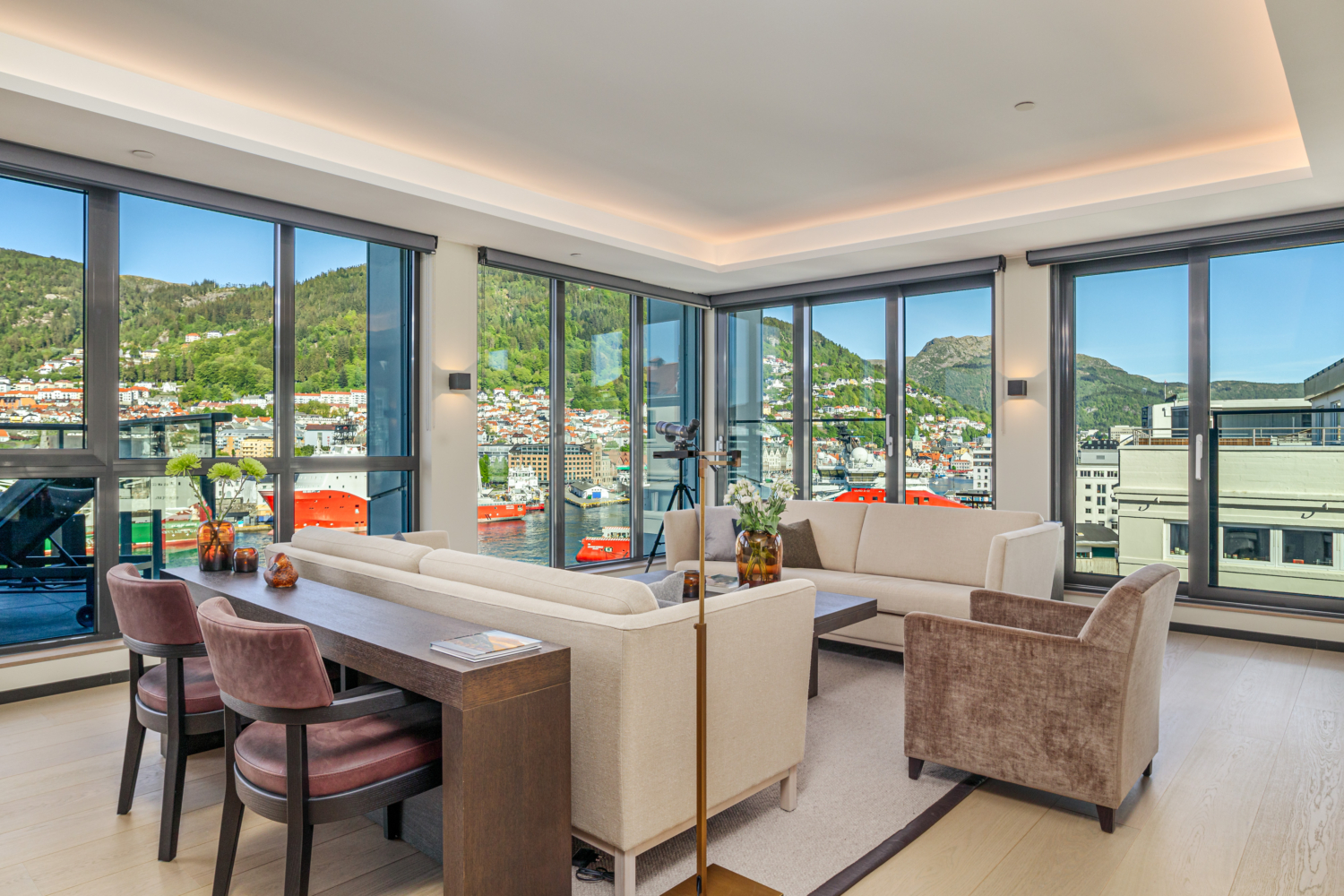 Luxurious modern living room with panoramic fjord views and large glass windows in Norway.