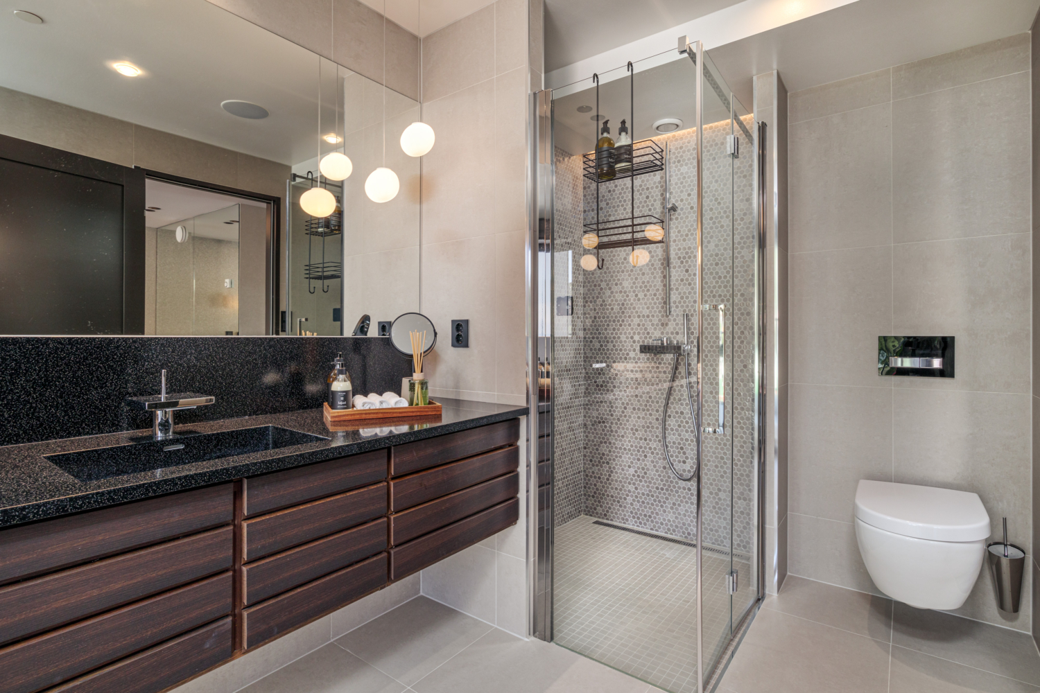 Modern bathroom with sleek dark wood vanity, glass walk-in shower, and contemporary fixtures for a luxurious feel.