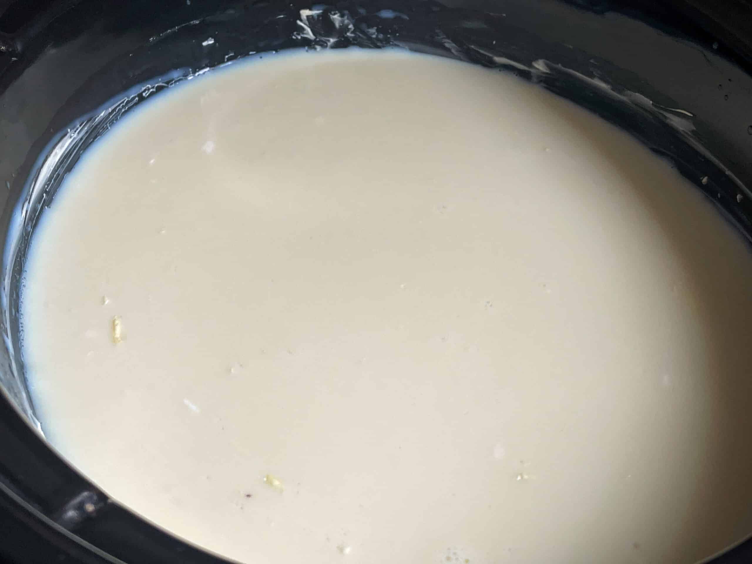 Milk added to slow cooker with the rice and sugar.