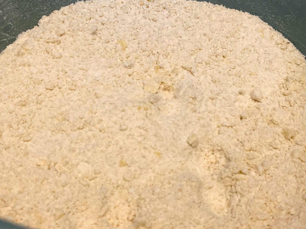 Margarine rubbed into flour in bowl.