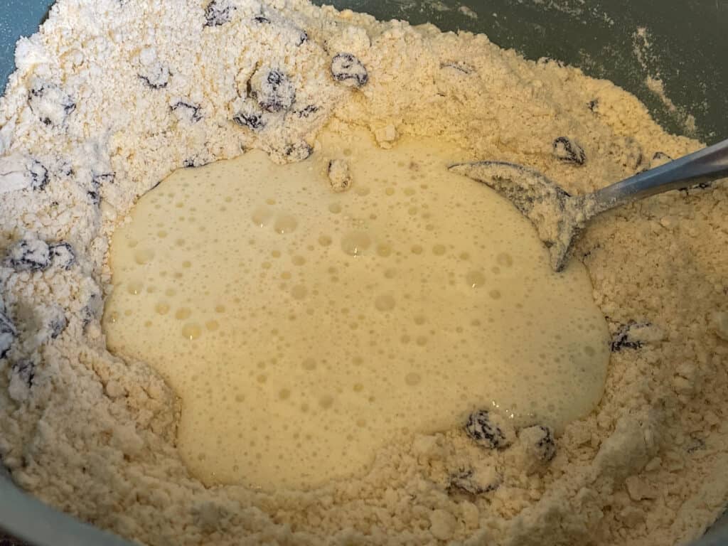 Buttermilk added to flour and currant mix.