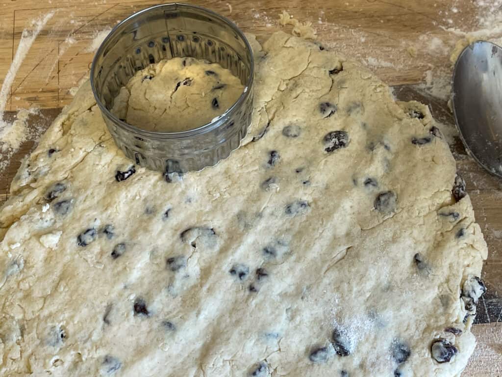 Scone dough patted down with a biscuit cutter on top.
