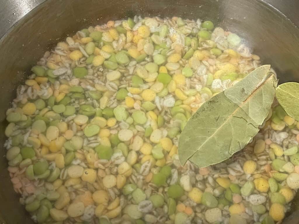 Soaked soup broth mix in soup pan with water and bay leaf.