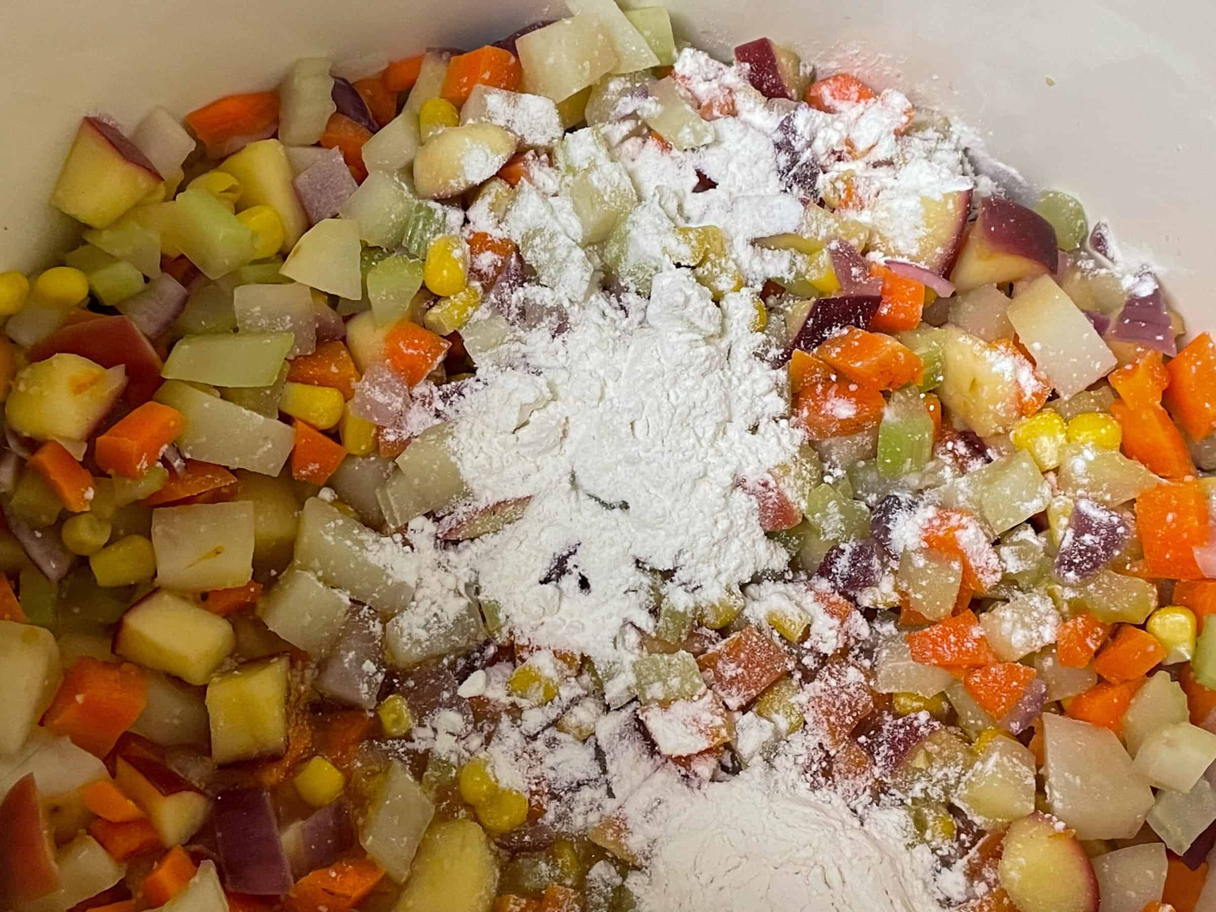 Flour added to veggies in soup pot.