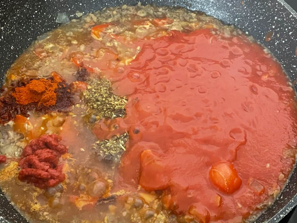 tomato passata and flavourings added to sautéed veggies skillet.