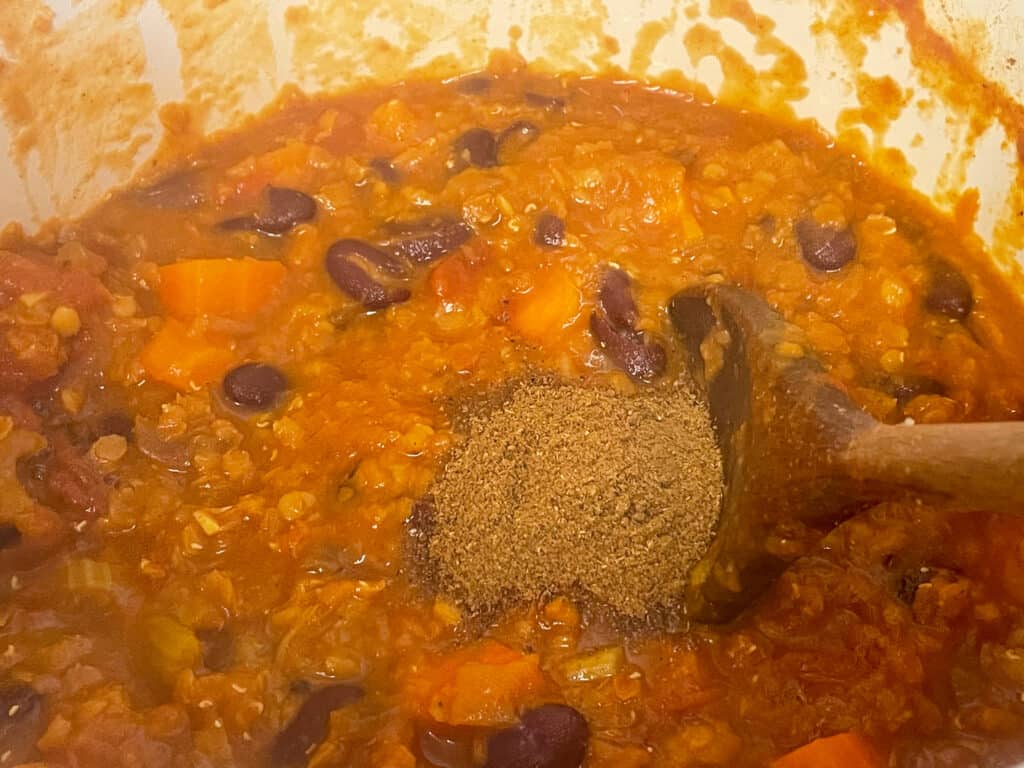 lasagna lentil mix cooked and garam masala mixed through in pan.