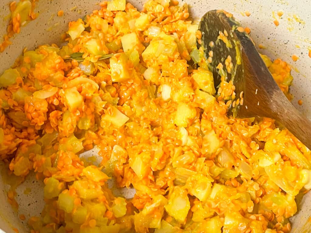 Lentils added to pie filling in the saucepan.