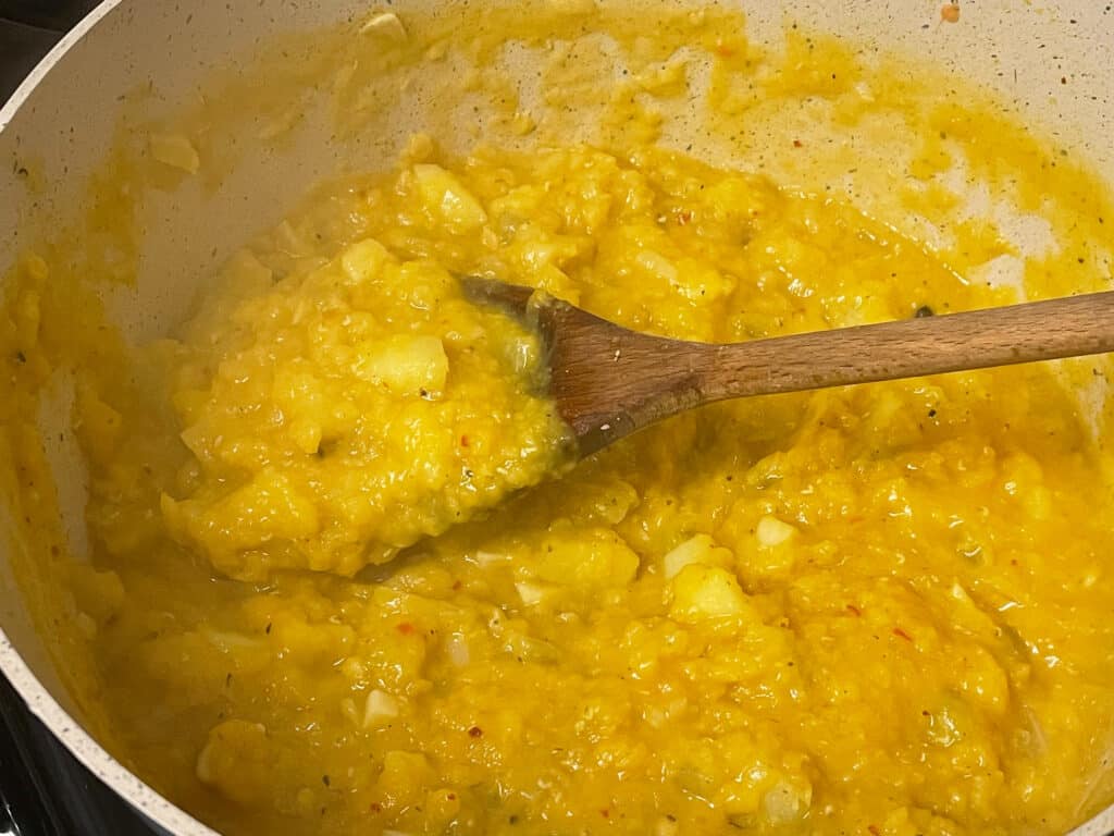 Stock added to pie filling cooking in saucepan.