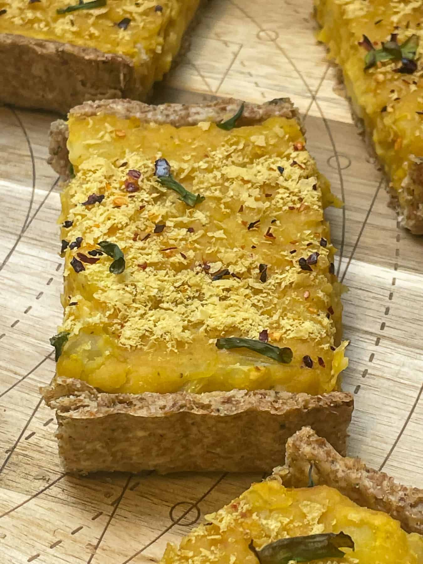 Slices of harvest pie on wooden cutting board.