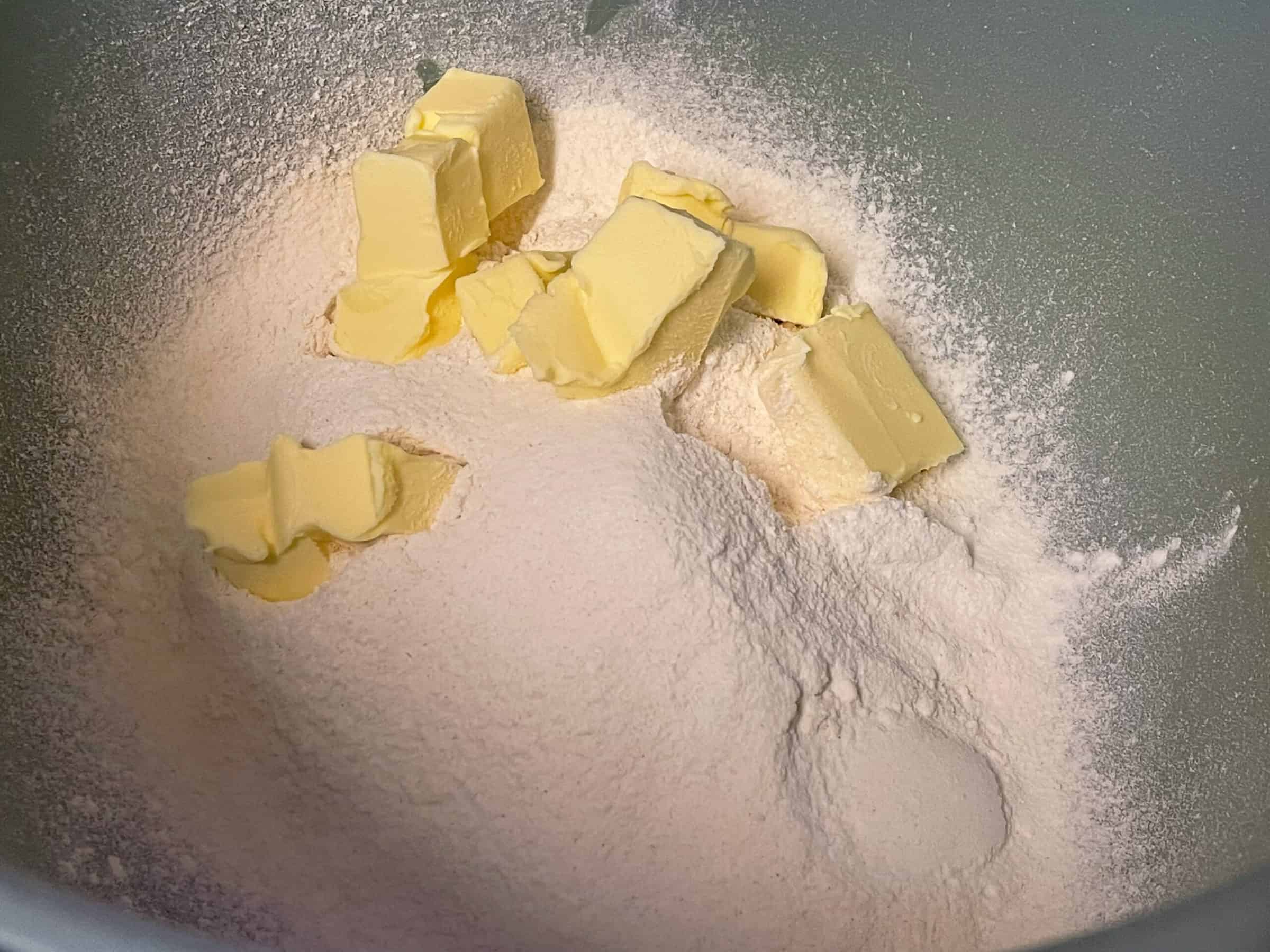 butter and flour in green mixing bowl, for rock cakes.