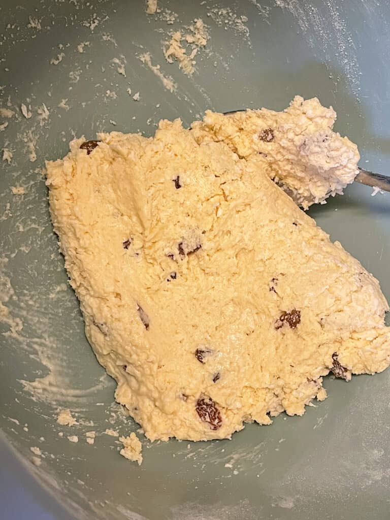 plant milk added to coconut rock cake mix and brought together into a dough in mixing bowl.