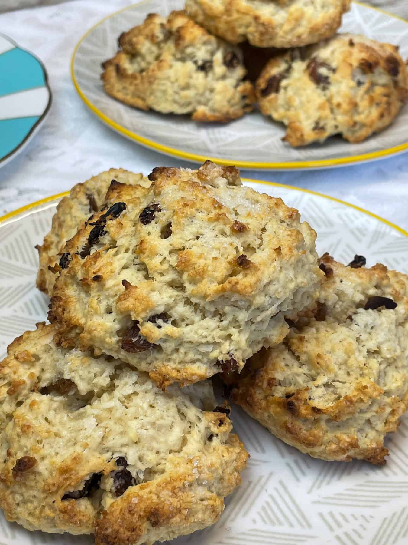 featured image for vegan Jamaican rock cakes close up, 2 plates of buns with third plate to side.