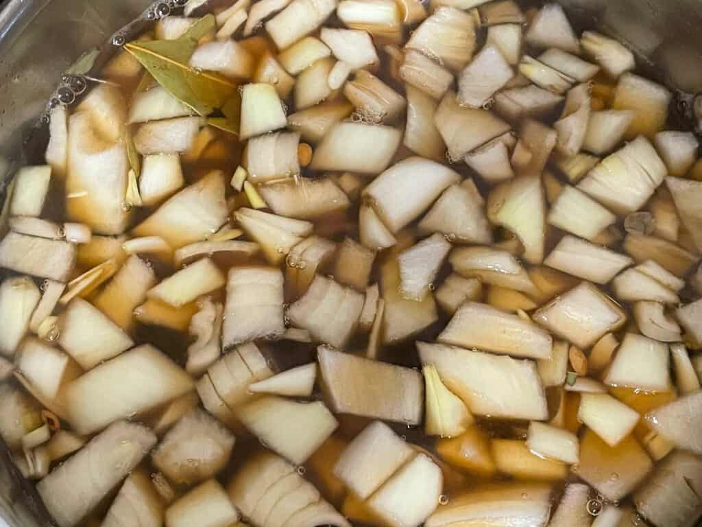 vegetable stock added to lentils in pot.