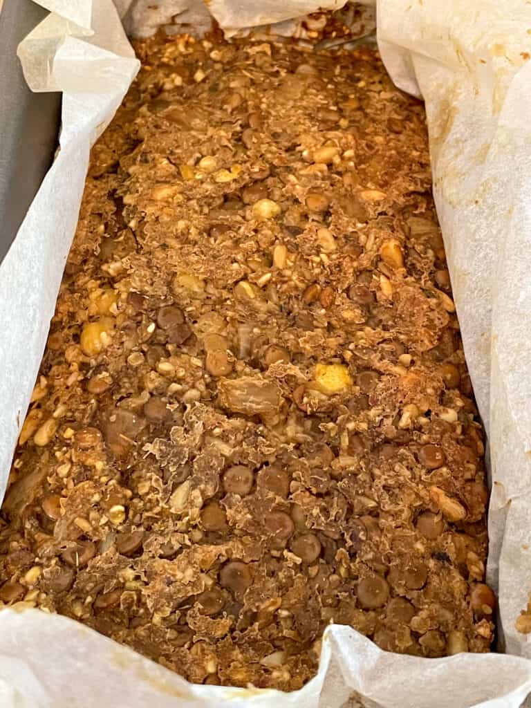 Vegan meatloaf with green lentils, chickpeas, and oatmeal, baked in loaf pan.