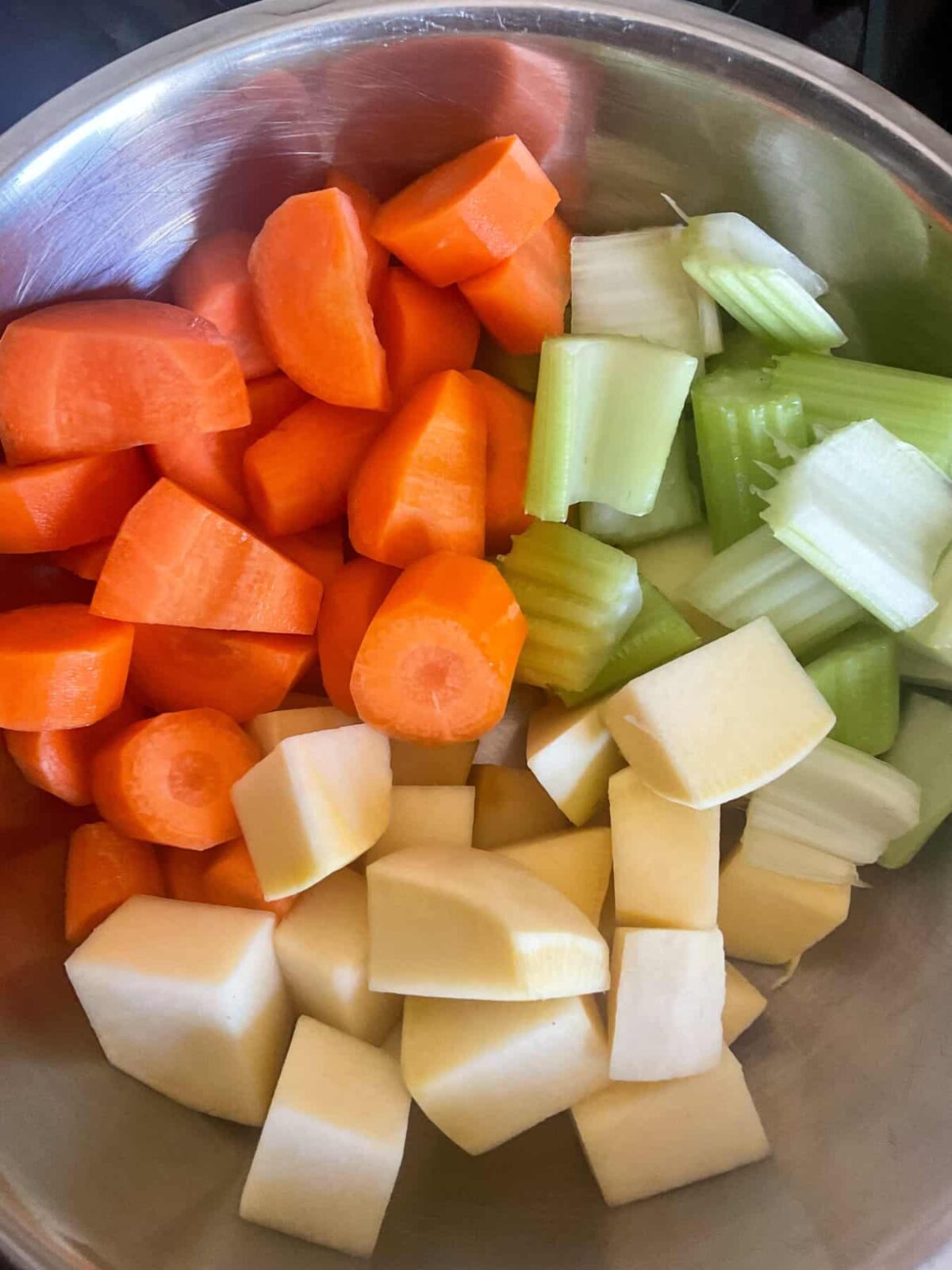 Vegetables chopped and in silver bowl.