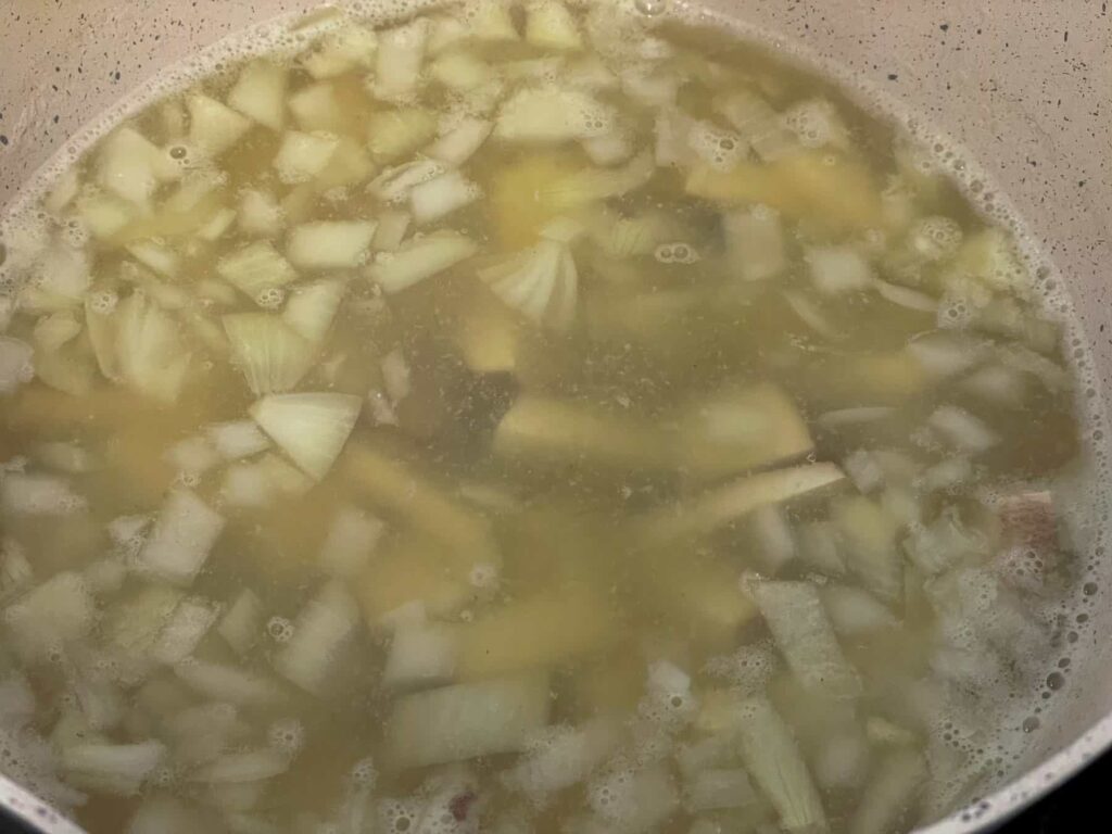smoked tofu pieces added to cream soup pan with the onions and veggie stock.