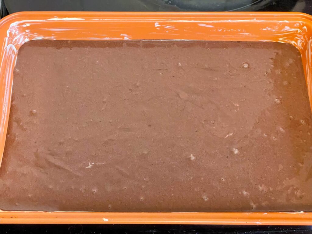 chocolate sponge traybake unbaked and in baking pan ready to pop in the oven.