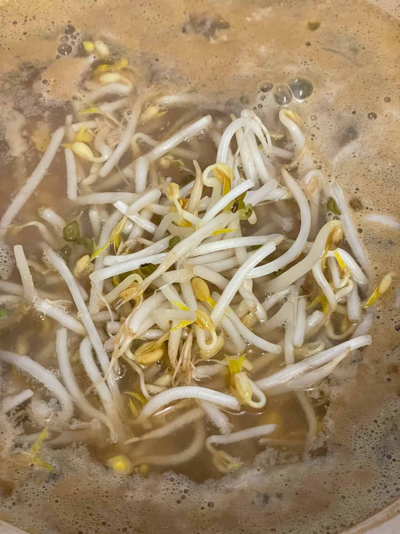 Bean sprouts tipped into the Chinese soup along with the cornflour slurry.